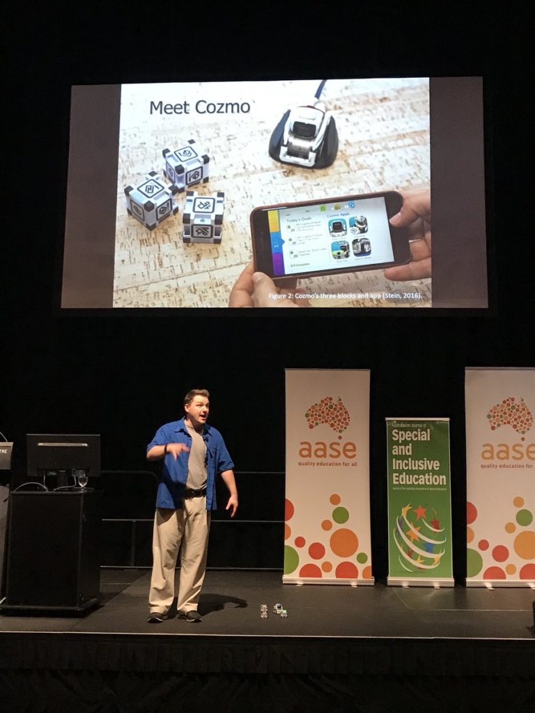 Dr K. Clark Burt presenting on classroom robotics at an AASE conference